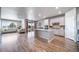 Bright, open-concept kitchen features a large island and modern appliances, seamlessly connecting to the living area at 17028 Osage St, Broomfield, CO 80023