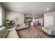 Open-concept living room with wood flooring and modern finishes, seamlessly flowing into the kitchen area at 17028 Osage St, Broomfield, CO 80023
