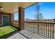 View of the patio with artificial turf and a green door on a brick condo in a suburban area at 9481 E Mansfield Ave # 203, Aurora, CO 80014