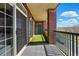 Spacious outdoor balcony with tile floors and a green accent wall, offering views of the surrounding area at 9481 E Mansfield Ave # 203, Aurora, CO 80014