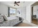 Bright bedroom featuring a ceiling fan, neutral carpet and walls, and balcony access at 9481 E Mansfield Ave # 203, Aurora, CO 80014