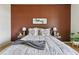 Bedroom features a cozy bed with decorative pillows and blanket, plus side tables with lamps at 9481 E Mansfield Ave # 203, Aurora, CO 80014
