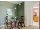 This modern dining area includes a stylish round glass table and dark wood chairs at 9481 E Mansfield Ave # 203, Aurora, CO 80014