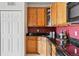 Kitchen area showcases wood cabinets, black appliances, and sleek countertops at 9481 E Mansfield Ave # 203, Aurora, CO 80014