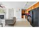 Open-concept living space with modern kitchen, fireplace, and comfortable seating arrangements at 9481 E Mansfield Ave # 203, Aurora, CO 80014