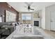 Bright living room with a fireplace, ceiling fan, and view of the balcony and landscape at 9481 E Mansfield Ave # 203, Aurora, CO 80014