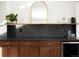 Stylish bar area with dark cabinets, black backsplash, and wooden countertop at 4565 Elm Ct, Denver, CO 80211