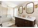 Beautiful bathroom with double vanity, natural stone and glass shower at 4565 Elm Ct, Denver, CO 80211