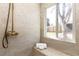 Bright bathroom boasting stone-look tile walls, a brass shower system, and a built-in bench seat at 4565 Elm Ct, Denver, CO 80211