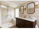 Modern bathroom featuring double sinks, and a glass-enclosed shower with gorgeous gold fixtures at 4565 Elm Ct, Denver, CO 80211