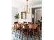 Open dining room with wood table, modern chandelier, and natural lighting at 4565 Elm Ct, Denver, CO 80211