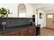 Wet bar area in the kitchen area, featuring dark cabinets, wine fridge and bar shelf at 4565 Elm Ct, Denver, CO 80211