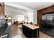 A wide shot of the kitchen and living spaces featuring hardwood floors and stainless appliances at 4565 Elm Ct, Denver, CO 80211