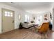 Cozy living room featuring wood floors, white walls, and comfortable seating at 4565 Elm Ct, Denver, CO 80211