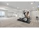 Spacious finished basement with neutral tones, recessed lighting, and walkout to exterior at 9130 Fraser River, Littleton, CO 80125