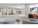 Large, finished basement offers flexible living space with fitness equipment, seating area, and natural light at 9130 Fraser River, Littleton, CO 80125