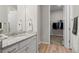 Well-lit bathroom featuring a granite vanity, towel holders, and closet access at 9130 Fraser River, Littleton, CO 80125