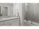 Modern bathroom features granite countertops, white cabinetry, and a glass-enclosed shower at 9130 Fraser River, Littleton, CO 80125