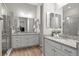 Bright bathroom with dual sinks, granite countertops, and a glass shower enclosure at 9130 Fraser River, Littleton, CO 80125