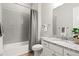 Bathroom featuring a tub with a gray shower curtain, gray tiles, and granite countertops at 9130 Fraser River, Littleton, CO 80125