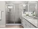 Modern bathroom featuring a glass shower enclosure, granite counters, and wood-look flooring at 9130 Fraser River, Littleton, CO 80125