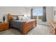 Bedroom with wood bed frame, carpet, and windows showing a view at 9130 Fraser River, Littleton, CO 80125