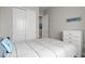 Bedroom featuring a large closet, picture frames, and a light blue pillow at 9130 Fraser River, Littleton, CO 80125