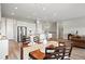 Open-concept dining area featuring wood floors, modern lighting, and seamless flow into the kitchen at 9130 Fraser River, Littleton, CO 80125