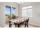 Dining room table with four chairs and sliding doors leading to an outdoor deck at 9130 Fraser River, Littleton, CO 80125