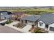 This is an exterior view showcasing the driveway, landscaping, and the home's architectural details at 9130 Fraser River, Littleton, CO 80125
