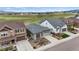 This exterior view captures the well-maintained landscaping, driveway, and the home's architectural charm at 9130 Fraser River, Littleton, CO 80125