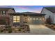 Warm, single Gathering home with a manicured front yard and a convenient two-car garage at 9130 Fraser River, Littleton, CO 80125