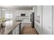 Spacious kitchen with white cabinetry, stainless steel appliances, and wood floors at 9130 Fraser River, Littleton, CO 80125