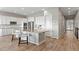 Bright, modern kitchen with white cabinets, stainless steel appliances, and a large island at 9130 Fraser River, Littleton, CO 80125