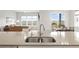 Open-concept kitchen with stainless steel sink and faucet at 9130 Fraser River, Littleton, CO 80125