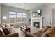 Cozy living room with a fireplace, large windows, and comfortable seating at 9130 Fraser River, Littleton, CO 80125