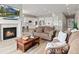 Open floor plan with fireplace and access to kitchen and dining room at 9130 Fraser River, Littleton, CO 80125