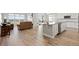Open concept living space with wood floors, a kitchen island, and large windows at 9130 Fraser River, Littleton, CO 80125
