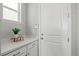 White mud room with a window, gray walls, cabinets and a counter at 9130 Fraser River, Littleton, CO 80125