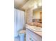 Vintage-style bathroom featuring a vanity, patterned wallpaper, and functional design at 1090 N Lafayette St # 504, Denver, CO 80218