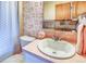 Retro bathroom featuring a vanity, patterned wallpaper, and vintage design elements at 1090 N Lafayette St # 504, Denver, CO 80218