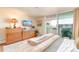 Comfortable bedroom featuring balcony access, ample natural light, and classic wooden furnishings at 1090 N Lafayette St # 504, Denver, CO 80218