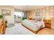 Serene bedroom with a sliding glass door to a balcony, complemented by unique wallpaper and neutral tones at 1090 N Lafayette St # 504, Denver, CO 80218