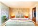 Stylish bedroom with balcony access, featuring unique wallpaper and decorative lighting at 1090 N Lafayette St # 504, Denver, CO 80218