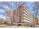 Attractive multi-story residential building with balconies, surrounded by lush landscaping and mature trees at 1090 N Lafayette St # 504, Denver, CO 80218