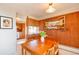Cozy dining room with wood paneled wall and table near kitchen, offering a warm and inviting space for meals at 1090 N Lafayette St # 504, Denver, CO 80218