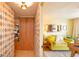 Hallway with a unique geometric-patterned wall and cork flooring leads to a bright living area at 1090 N Lafayette St # 504, Denver, CO 80218