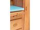 Details of a kitchen cabinet with retro hardware and modern turquoise countertops at 1090 N Lafayette St # 504, Denver, CO 80218