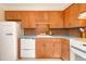 Bright kitchen featuring vintage style wooden cabinets, blue countertops, and modern appliances at 1090 N Lafayette St # 504, Denver, CO 80218