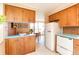 Open concept kitchen featuring wood cabinets, vintage fridge, and dining area with natural light at 1090 N Lafayette St # 504, Denver, CO 80218